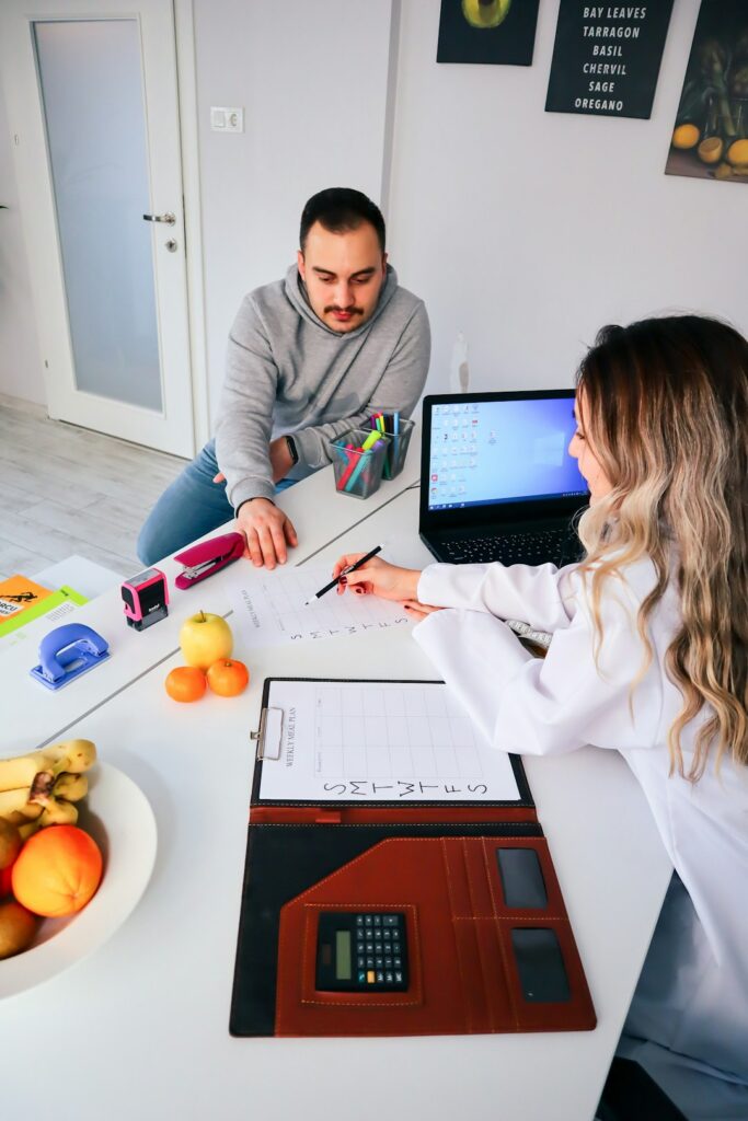 A homeowner reviews a credit report and insurance paperwork beside a calculator at a kitchen table.